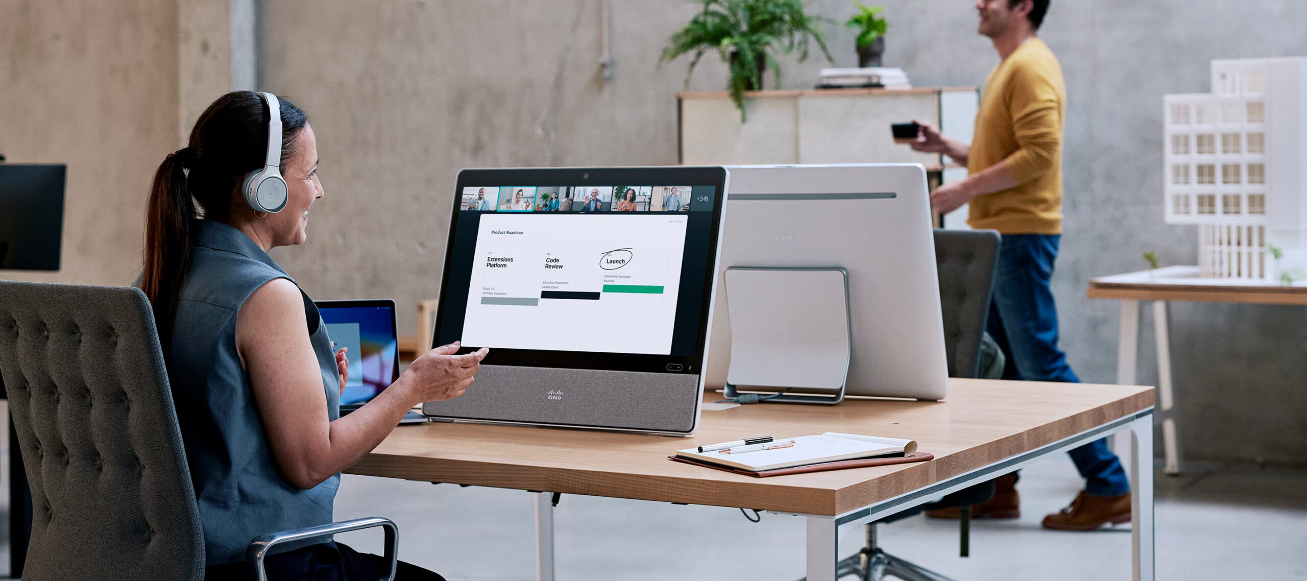 Professional using a desktop video collaboration system in a shared workspace